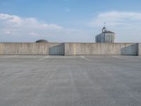 several large empty parking spaces in the city with buildings nearby in front of them -