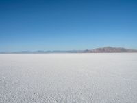 the view from an airplane of the vast expanse of salt flats and mountains in the distance