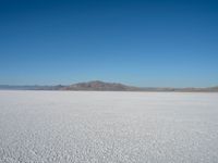 the view from an airplane of the vast expanse of salt flats and mountains in the distance