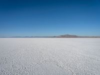 the view from an airplane of the vast expanse of salt flats and mountains in the distance