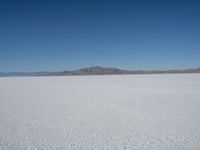 the view from an airplane of the vast expanse of salt flats and mountains in the distance