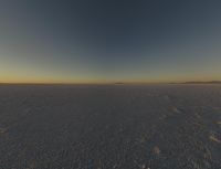 there are a bunch of footprints in the snow, with a sky background for a backdrop