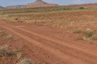 there is a bike that is in the middle of a dirt road in the desert