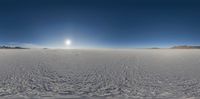 a wide view shows the sky and land from within a 3d globe lens view of snow covered ground