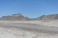 a red truck is driving through the rocky landscape of the desert of an arid area