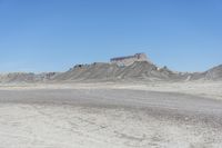 a red truck is driving through the rocky landscape of the desert of an arid area