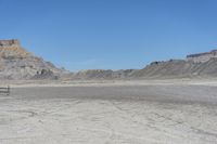 a red truck is driving through the rocky landscape of the desert of an arid area