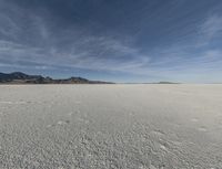 an open desert with no one yet on it and mountains behind it in the background