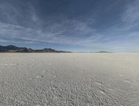 an open desert with no one yet on it and mountains behind it in the background