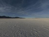 an open desert with no one yet on it and mountains behind it in the background