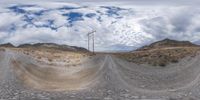 an image looking up at the sky from a hill top with a dirt road that has a stop sign at its corner