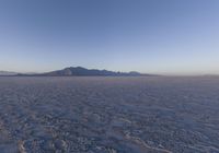 an empty open area, with mountains in the distance as a cameraman zooms by
