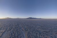 an empty open area, with mountains in the distance as a cameraman zooms by
