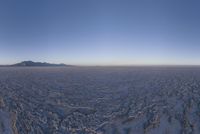 an empty open area, with mountains in the distance as a cameraman zooms by