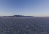 an empty open area, with mountains in the distance as a cameraman zooms by