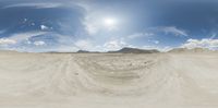 a panoramic view of a desert with no trees or vehicles in it with the sun in the background