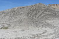 a red truck is driving through the rocky landscape of the desert of an arid area