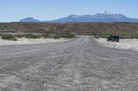 a red truck is driving through the rocky landscape of the desert of an arid area