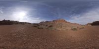 a picture taken with a fisheye lens in the desert mountains at high speed in front of a sky