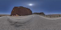 a desert landscape is shown through the 3d glasses of a man on a motorcycle riding along an empty paved road