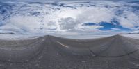 the distorted image is taken through a fish eye lens of an asphalt road with yellow marking