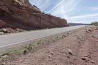 Utah Desert Road: Red Rock Mountains and Clear Skies