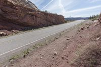 Utah Desert Road: Red Rock Mountains and Clear Skies