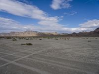 the vast arid desert area is dry and barren, with sparse scrub in the foreground