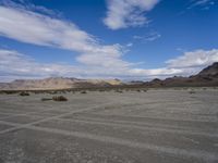 the vast arid desert area is dry and barren, with sparse scrub in the foreground