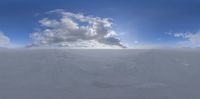 there is only one cloud in the sky on this snowy landscape that's quite surreal