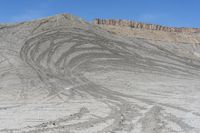 a red truck is driving through the rocky landscape of the desert of an arid area