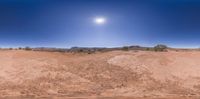 a 360 - view shot of a large desert landscape under the sun and in the sky