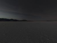 a lone white car traveling on the desert surface during sunset time in the daytime time