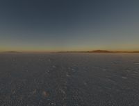 a desert landscape at sunset with an airplane in the sky, on the horizon are mountains and small snow flakes