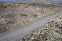 the truck is driving down the road in the desert terrain area of this area of mountains