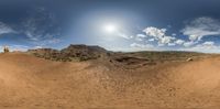 a big desert with a person standing on the ground, in the middle of the desert