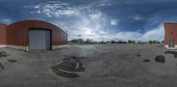 the view from behind the vehicle garage door shows an underground drain on the ground beneath the door and in front of it is a fire station