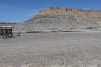 a red truck is driving through the rocky landscape of the desert of an arid area