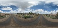 the image is distorted by the 360 lens of a bike rider in the desert,