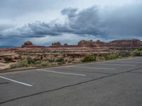 a parking lot with no one in it, and dark clouds above the scene on top