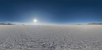 an image of a view looking towards a snow covered field with clouds in the sky