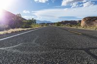 the sun shines brightly on an empty road that is not quite visible as if it was going through the desert