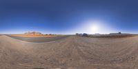 a fisheye lens captures a desert setting and street scene from the outside looking out