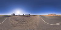 a fisheye lens captures a desert setting and street scene from the outside looking out