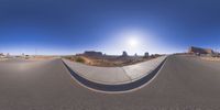 a fisheye lens captures a desert setting and street scene from the outside looking out