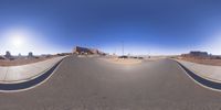 a fisheye lens captures a desert setting and street scene from the outside looking out