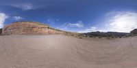 a fisheye lens captures a desert setting and street scene from the outside looking out