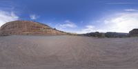 a fisheye lens captures a desert setting and street scene from the outside looking out