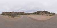 a fisheye lens captures a desert setting and street scene from the outside looking out