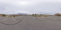 a fisheye lens captures a desert setting and street scene from the outside looking out